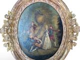 an oval picture frame with a painting of a man and a woman