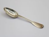 silver spoon on a white table with a white background