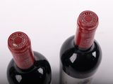 two bottles of wine sitting next to each other on a table
