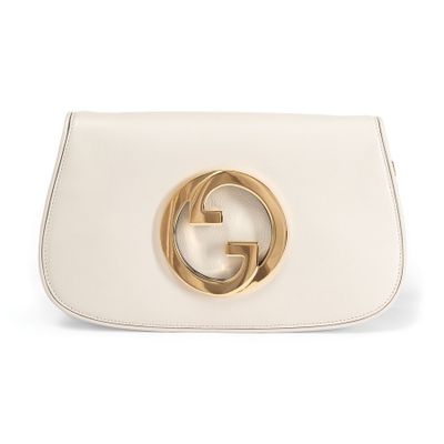 a white gucci bag with a gold buckle on the front