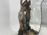 an image of a statue of a woman holding a mirror