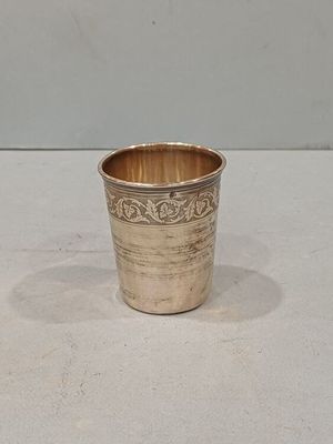 a silver cup that is sitting on a table