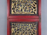 two red and gold boxes with carvings on them sitting on a table