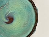 a close up view of a bowl with a swirl in it