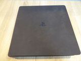 a close up of a playstation laptop on a wooden table
