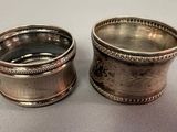 pair of antique silverplated napkin holders on a table