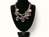 silver chain and pearl necklace on a mannequin display