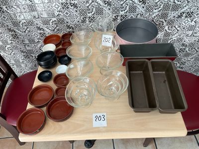 a table that has many bowls and pans on it
