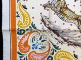 an orange and white scarf with a cheetah and a leopard on it