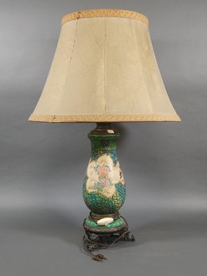 an image of a lamp with a green base and a beige shade