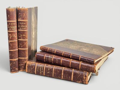several old books are stacked on top of each other on a table