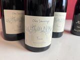 several bottles of wine are lined up on a table