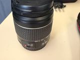 a camera lens sitting on a table next to a cell phone