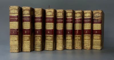 several old books are lined up in a row on a table