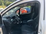 the interior of a car with the door open and the driver ' s seat down