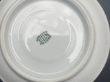 a white plate with a green design on it