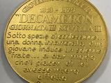 a close up of a gold coin on a white surface