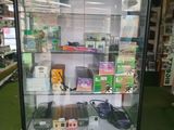 a display case with electronic devices in it in a store