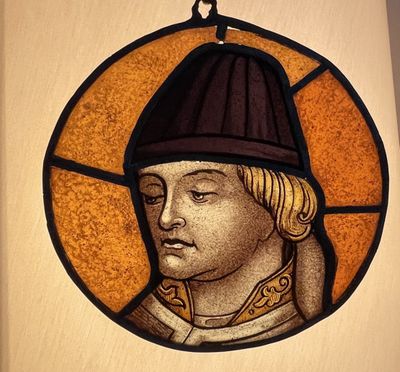 a stained glass picture of a man wearing a hat