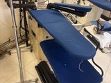 a blue ironing board sitting on a table in a room