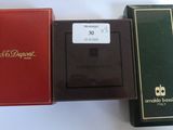 three boxes of cigarettes sitting next to each other on a white surface