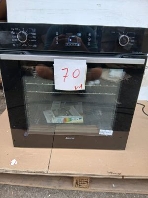 a black oven sitting on a cardboard box with a price tag on it