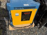 a blue and yellow machine that is sitting on the ground
