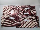 four brown and white zebra print pajama pants on a white surface
