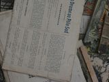 a box full of old books and papers on a table