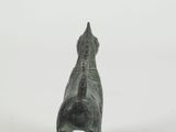 a small statue of a dog that is standing on its hind legs
