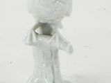 a small figurine of a woman holding a bird