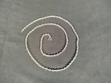 a silver chain that has been placed on a table