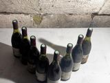 several bottles of wine lined up in a row on a table