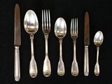 five spoons, a knife, and a fork on a black background