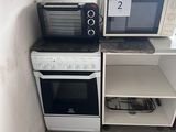 two microwaves and a toaster oven in the corner of a kitchen
