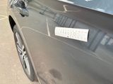 a car with a sticker on the side of it ' s door