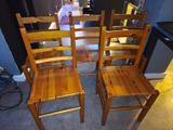 three wooden chairs sitting next to each other in a room