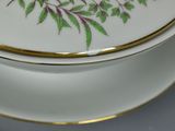 a white plate with a green and purple design on it