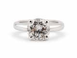a white gold engagement ring with a round brilliant cut diamond