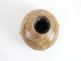 a brown vase with a black lid on a white surface