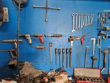 many tools hanging on the wall in the garage