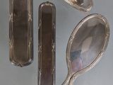 three silver spoons and a mirror on a gray surface