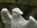 a statue of a bird that is sitting on a table