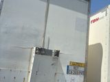 a white truck that is parked next to another truck