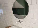 a bathroom with a sink and a mirror on the wall