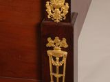 an image of a bed with a wooden frame and gold decorations on the headboard
