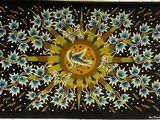 painting of a sunflower on a black background with blue and yellow flowers