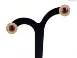 a close up of a pair of earrings on a black stand