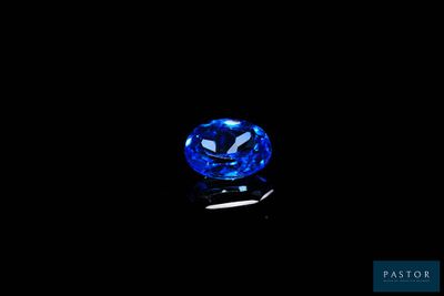 a blue sapphire stone on a black background