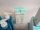 a bottle of water next to two boxes of soap